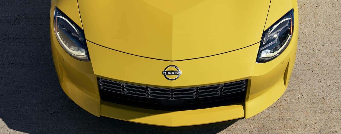 A yellow 2023 Nissan Z is shown from the front after leaving a Minooka Nissan dealer.