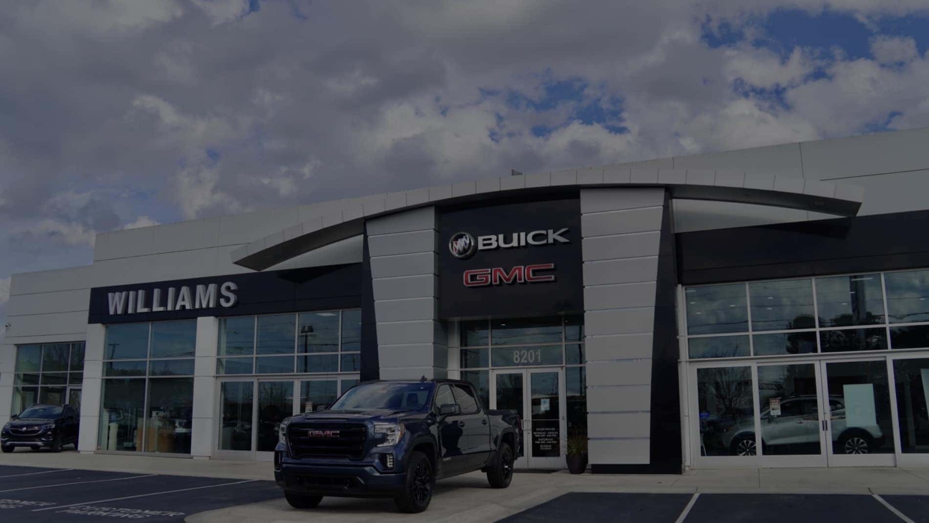 An exterior shot of a Buick/GMC dealership building