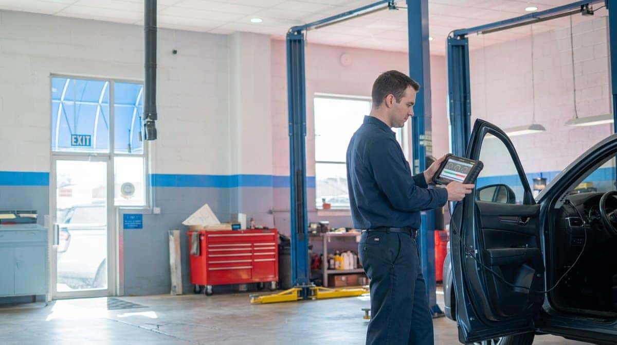 A Yoder Chevrolet technician running a diagnostic scan tool on a customer vehicle in Fort Lupton