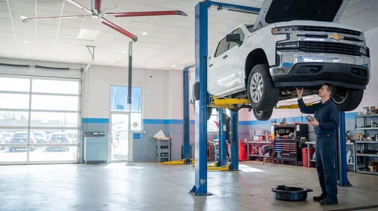 A Yoder Chevrolet technician fitting a new oil filter during an oil change in Fort Lupton
