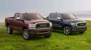 A maroon and a blue Ram 1500 are parked on a grassy field in Florence, KY.