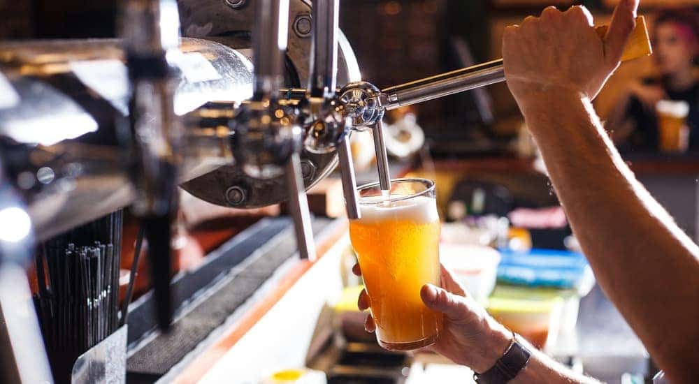 Beer is being poured into a glass from a tap.