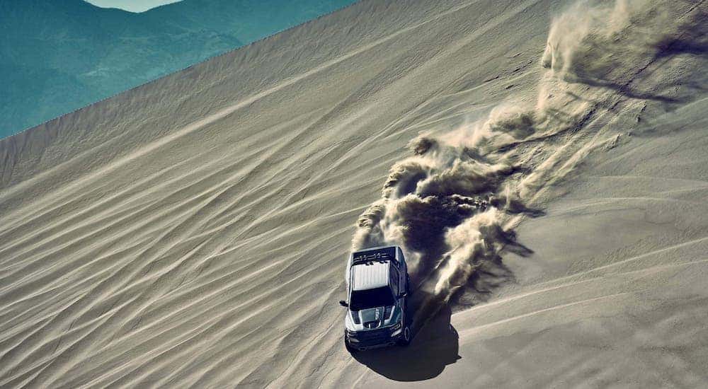 A silver 2021 Ram 1500 TRX is shown from above while driving in a sand pit near Florence, KY.