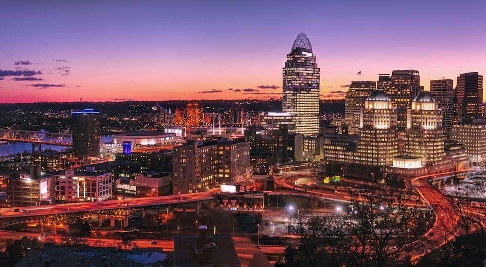 The sun is setting on the skyline of Cincinnati.