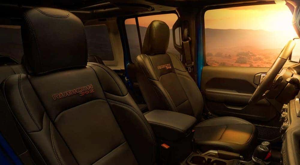 The black interior of a 2021 Jeep Wrangler Rubicon 392 is shown at sunset.