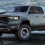 A pale blue 2021 Ram 1500 TRX is angled left parked in standing water.