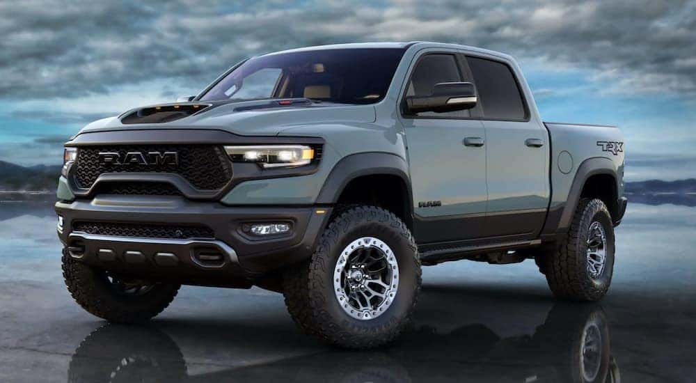 A pale blue 2021 Ram 1500 TRX is angled left parked in standing water.