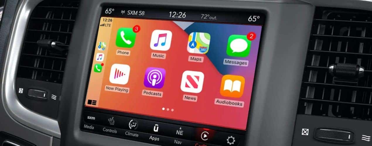 The interior of a 2022 Ram 1500 shows the infotainment screen.