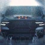 A grey 2021 Ram 1500 TRX is shown splashing through water.