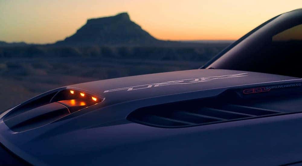 The hood of a 2021 Ram 1500 TRX is shown close up during a sunset.
