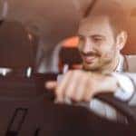 A man is shown driving a car.