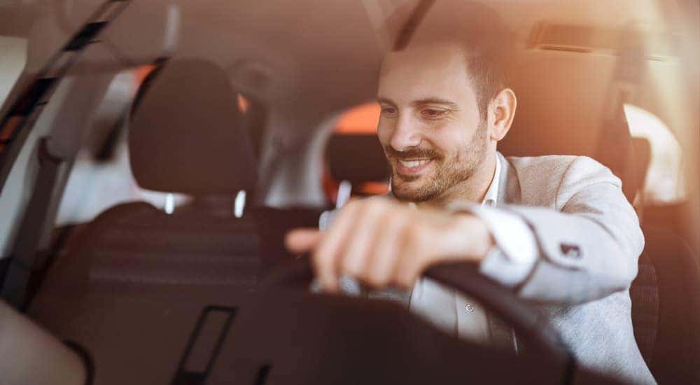A man is shown driving a car.