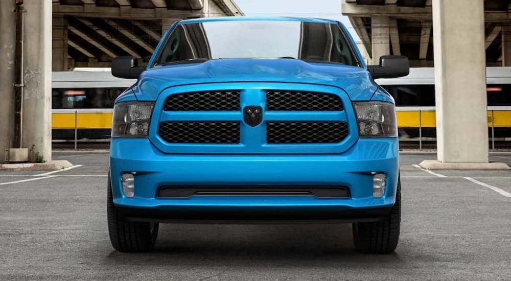 A blue 2020 Ram 1500 is shown from the front parked in a parking garage.