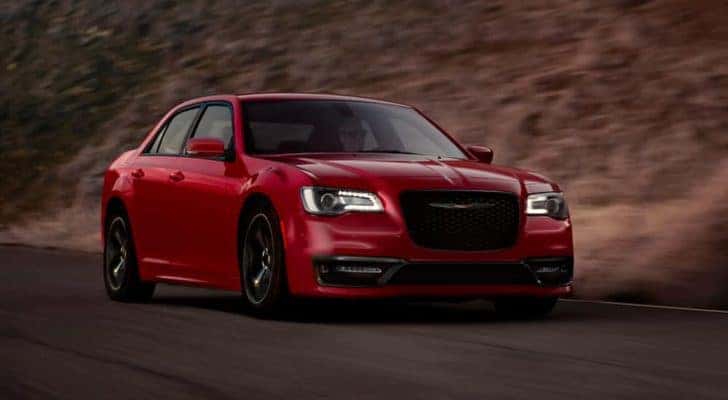 A red 2020 Chrysler 300 is shown driving on a road after leaving a Certified Pre-Owned Chrysler dealer.