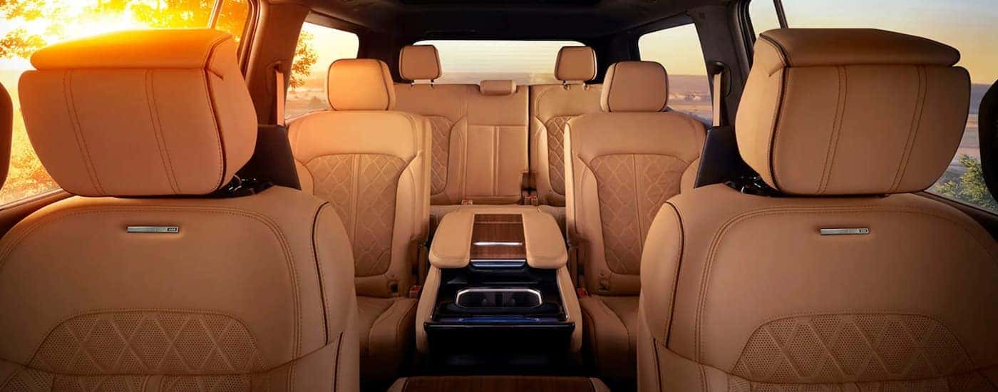 The tan interior of a 2022 Grand Wagoneer shows three rows of seating.