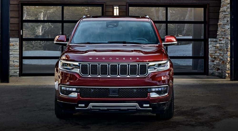 A red 2022 Wagoneer is shown from the front parked in front of a modern building after leaving a Cincinnati Wagoneer dealer.