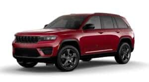 A red 2022 Jeep Grand Cherokee is angled left.