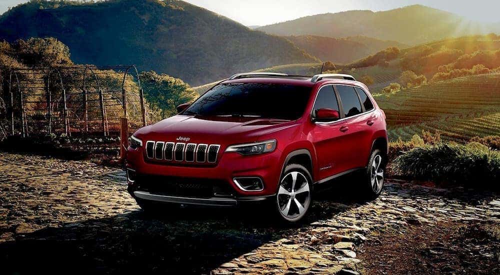 A red 2019 Jeep Cherokee is shown from the front parked in the mountains after leaving a Cincinnati used car dealer.
