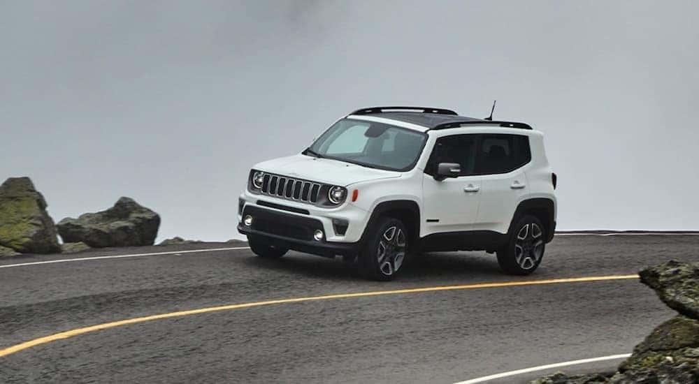A white 2022 Jeep Renegade Sport is shown from the side while rounding a corner.