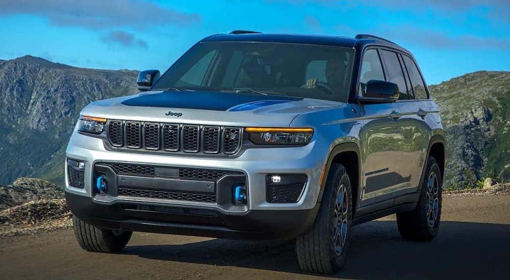 A silver 2022 Jeep Grand Cherokee 4xe is shown from the front at an angle after leaving a Oakbrook Jeep dealership.