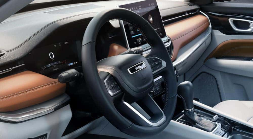The black steering wheel of a 2022 Jeep Compass is shown in close up at a Cincinnati Jeep dealer.