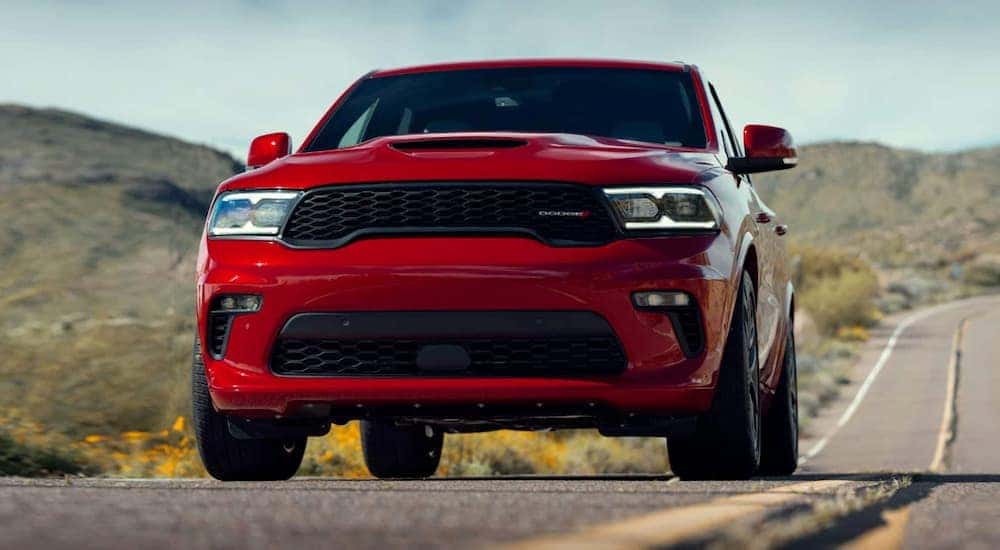 A red 2021 Dodge Durango is shown from the front on an open road.