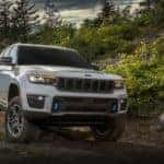 A grey 2022 Jeep Grand Cherokee 4xe is shown on a dirt trail.