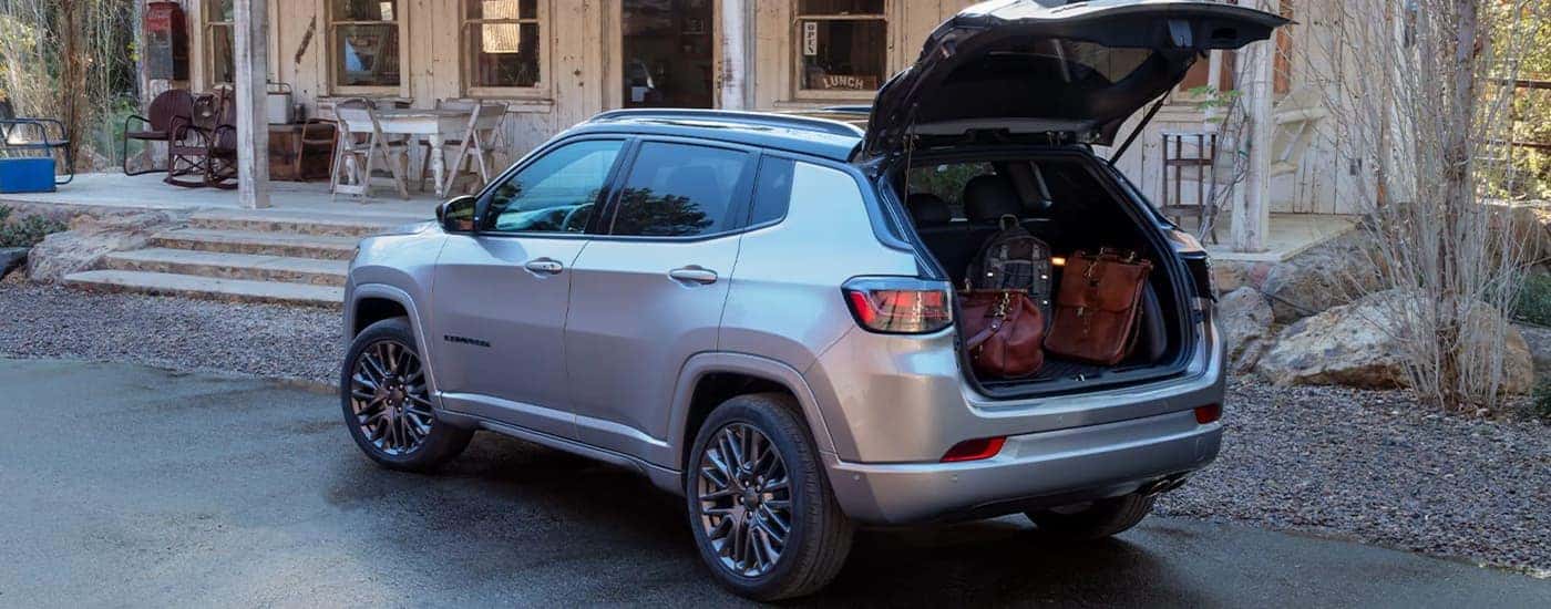 A silver 2022 Jeep Compass is shown at a rear angle with the liftgate open.