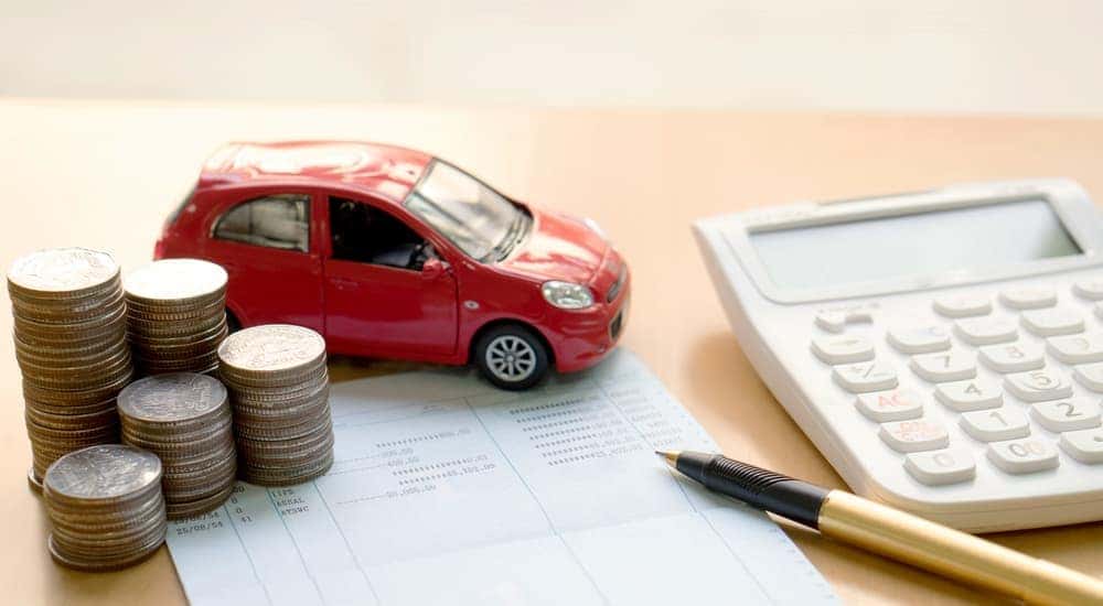 A red car is shown on car valuing paperwork.
