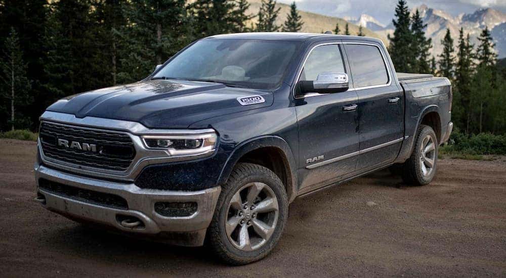 A blue 2022 Ram 1500 is shown from the side after leaving a Certified Pre-Owned Ram dealer.