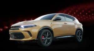 A yellow 2023 Dodge Hornet is angled left.
