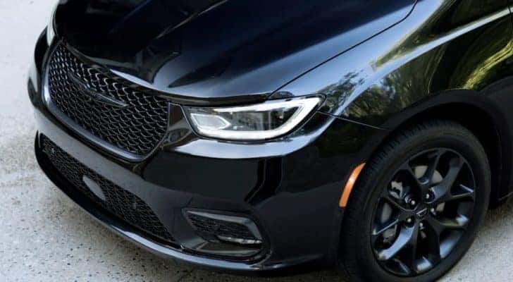 A close up of the front of a black 2023 Chrysler Pacifica Limited for sale is shown.