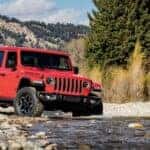 A 2020 Jeep Gladiator Rubicon is shown off-roading after visiting a used Jeep dealer.
