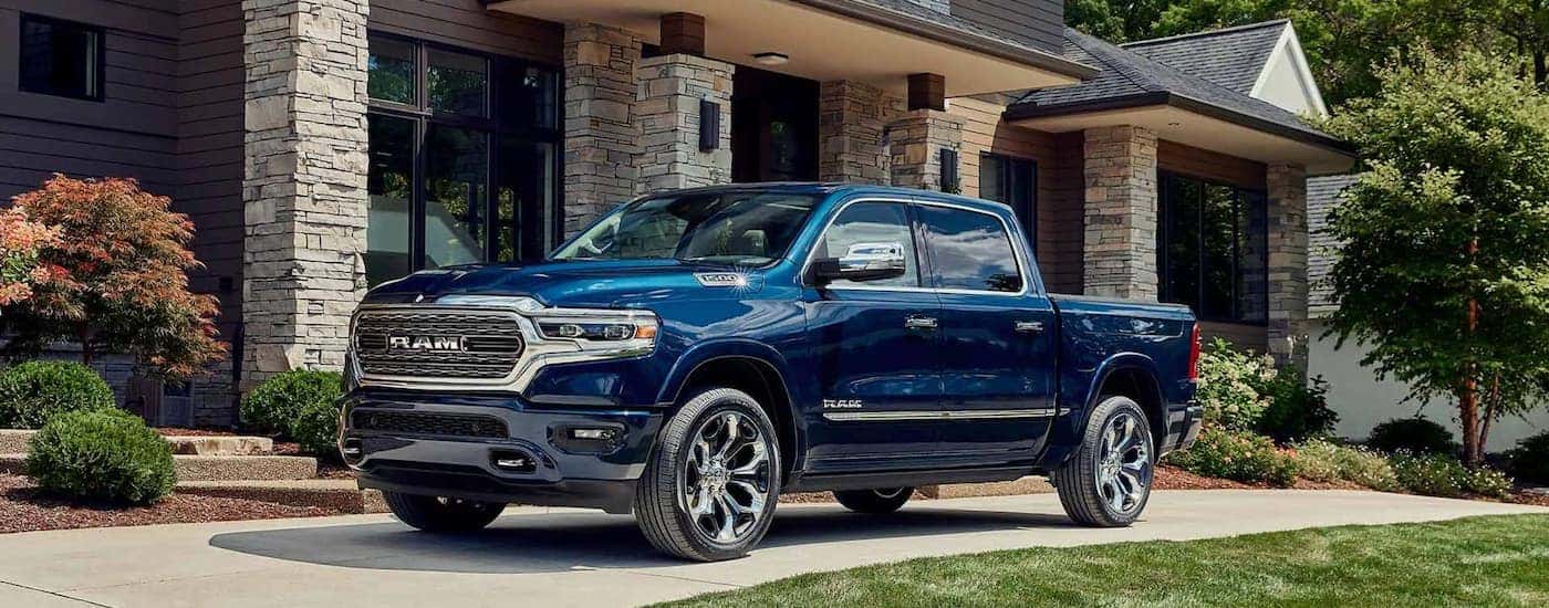 A blue 2023 Ram 1500 is shown parked in a driveway.