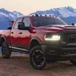 A red 2023 Ram 2500 Rebel HD is shown parked near a cliff after viewing Ram 2500 trucks for sale near Covington, KY.