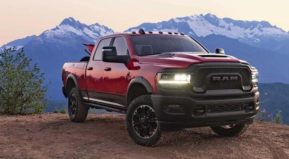 A red 2023 Ram 2500 Rebel HD is shown parked near a cliff after viewing Ram 2500 trucks for sale near Covington, KY.