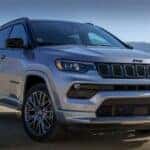 A silver 2023 Jeep Compass is shown parked near mountains after visiting a Jeep Compass dealer near Alexandria, KY.