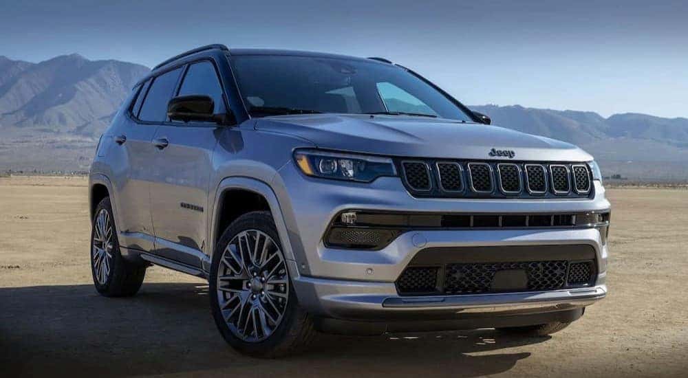 A silver 2023 Jeep Compass is shown parked near mountains after visiting a Jeep Compass dealer near Alexandria, KY.