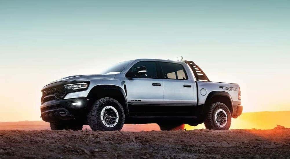 A silver 2023 Ram 1500 TRX is shown parked off-road.