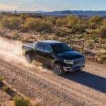 A grey 2019 Ram 1500 is shown on a dirt trail.