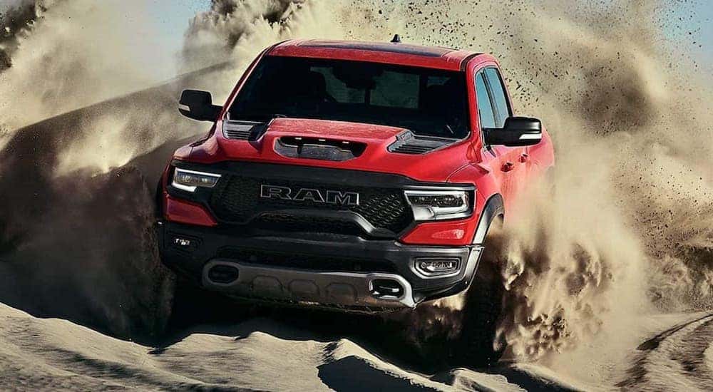 A red 2021 Ram 1500 TRX is shown from the front while off-road.