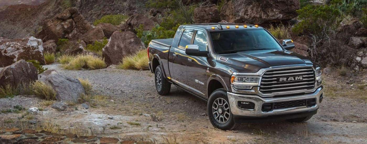 A grey 2021 Ram 1500 Limited Longhorn is shown parked on a gravel road.