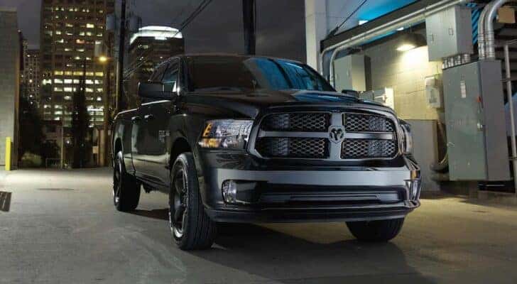 A black 2022 Ram 1500 Classic is shown parked on a city street at night.