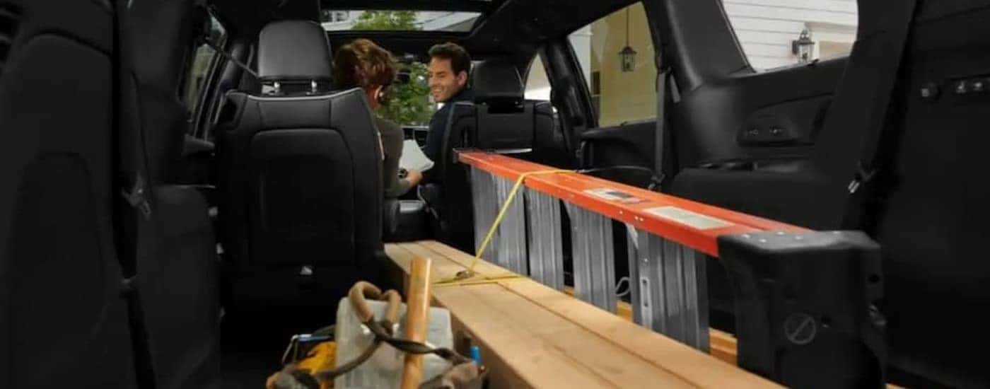 A ladder is shown in the rear cargo area of a 2023 Chrysler Pacifica.