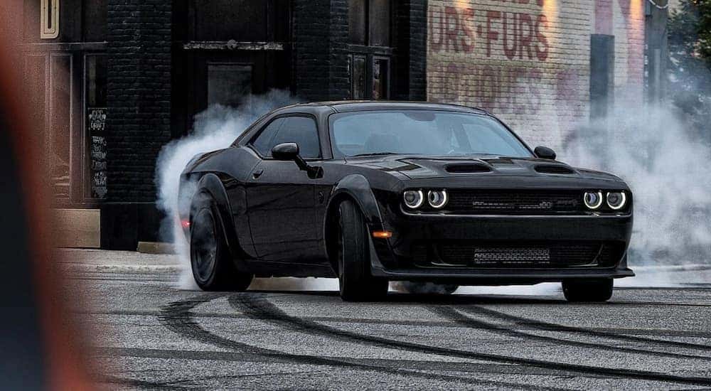 A black 2023 Dodge Challenger Hellcat Redeye Widebody is shown from the front at an angle after leaving a Dodge dealer near me.