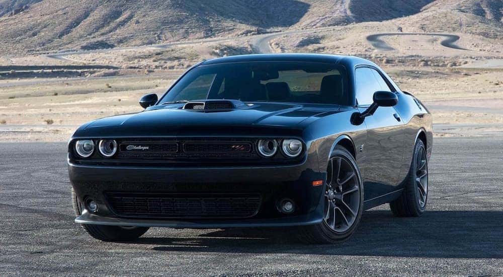 A black 2021 Dodge Challenger RT Scat Pack is shown parked on a racetrack.
