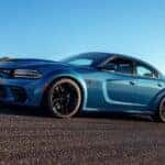 On my way to sell my car, a blue 2021 Dodge Charger SRT, is shown driving on a road.