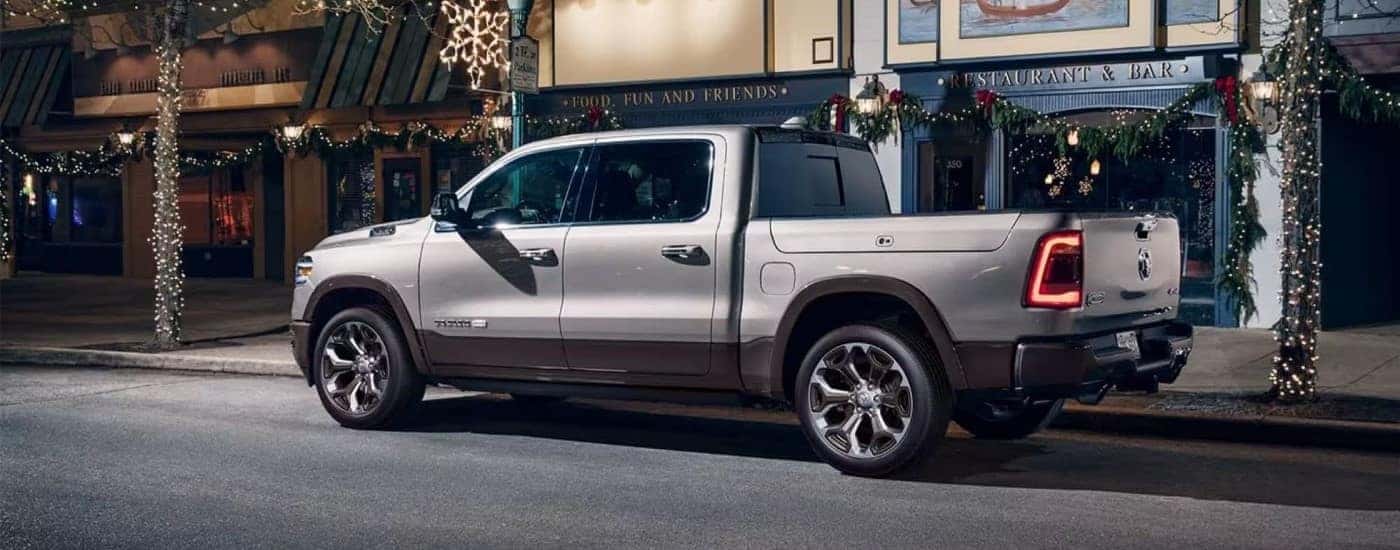 A grey 2020 Ram 1500 Classic is shown parked near a city curb.