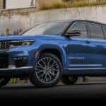 A blue 2023 Jeep Grand Cherokee is shown from the front at an angle after leaving a dealer that has a Jeep Grand Cherokee for sale.