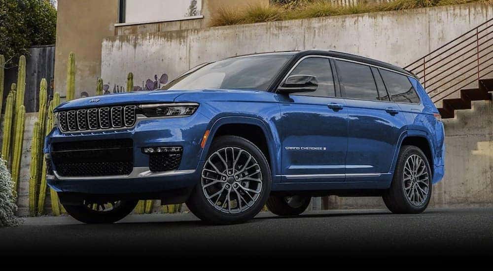 A blue 2023 Jeep Grand Cherokee is shown from the front at an angle after leaving a dealer that has a Jeep Grand Cherokee for sale.